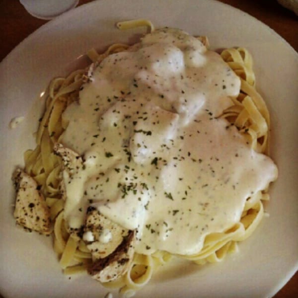 Fettuccine Alfredo with chicken and herbs, a classic Italian dish from The Grinders & Spaghetti House.